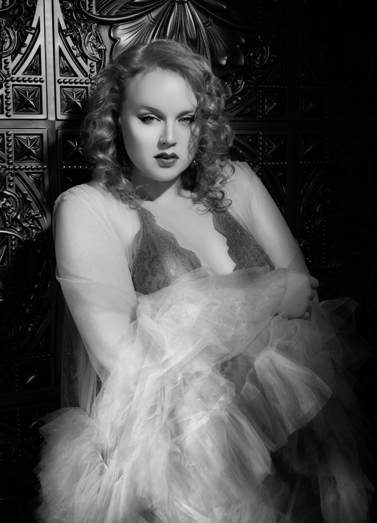 Sultry black and white boudoir portrait of woman with tulle robe and lace bodysuit by Paolo Portraits - Charleston SC